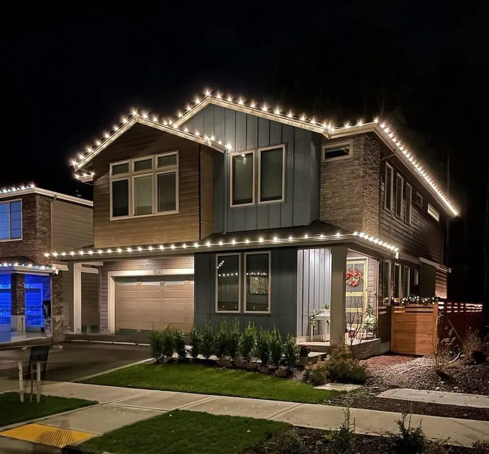 Modern two story home with warm white roofline lights