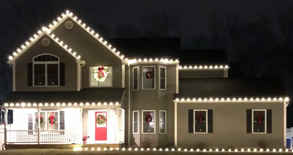 Two story roofline outlined in warm white C9 bulbs