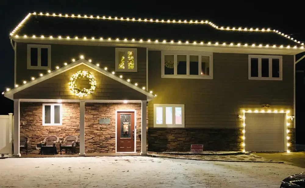 Roofline lights with a lit wreath over the front door