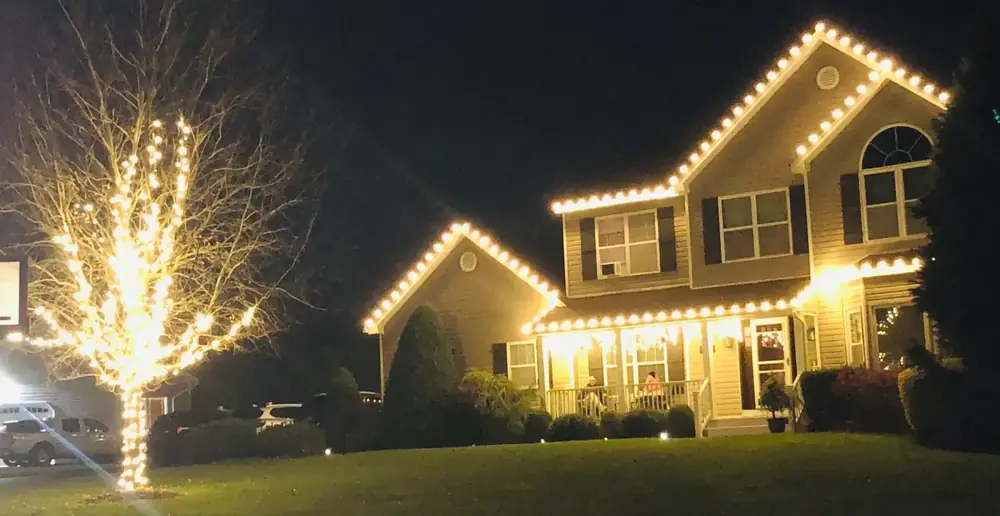 Wrapped front yard tree and warm white roofline lights